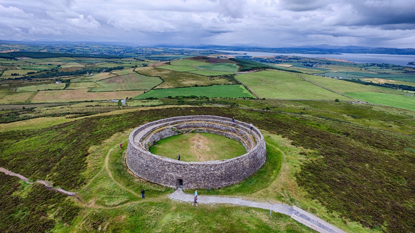 A round stone fort on a hilltop, fields and water spreading out behind it, 10:52 am, July 16.
