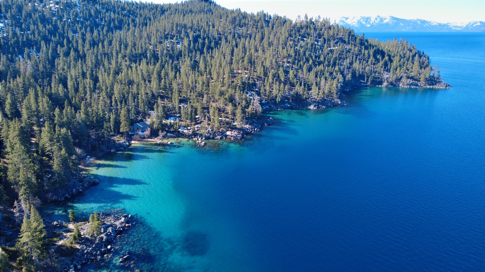 10:10. Along the shore, with snowy mountains across the lake.