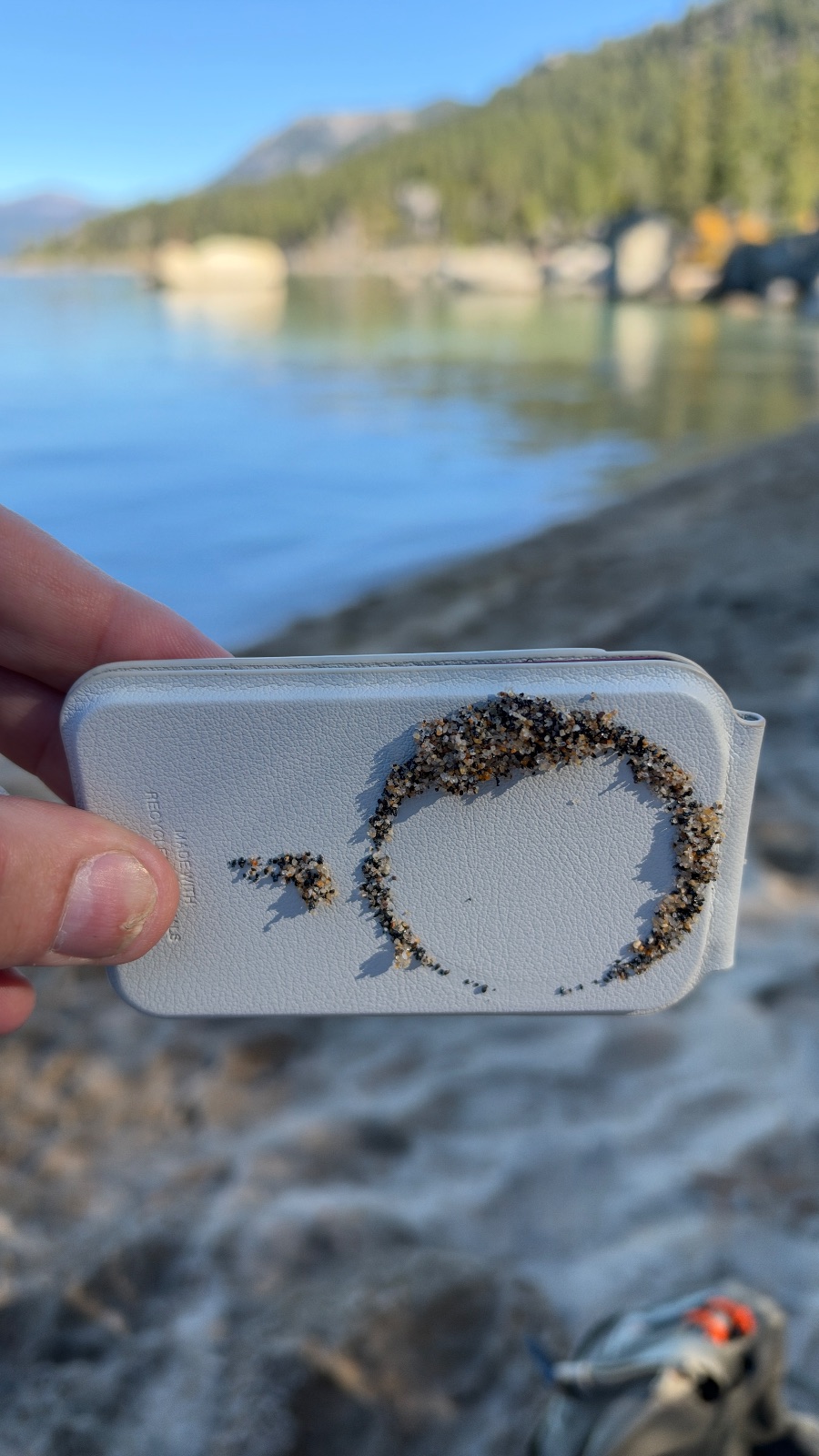 10:35. Dark beach sand stuck in a ring on the back of my phone wallet.
