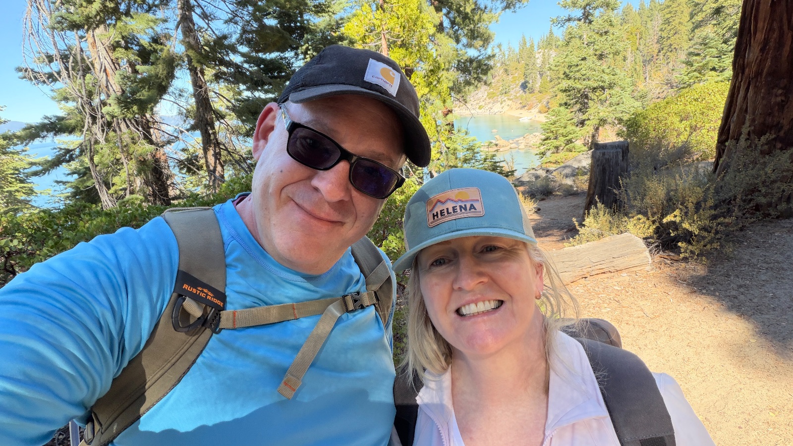 11:55. One last selfie with Helena on the way back up, the lake through the trees.
